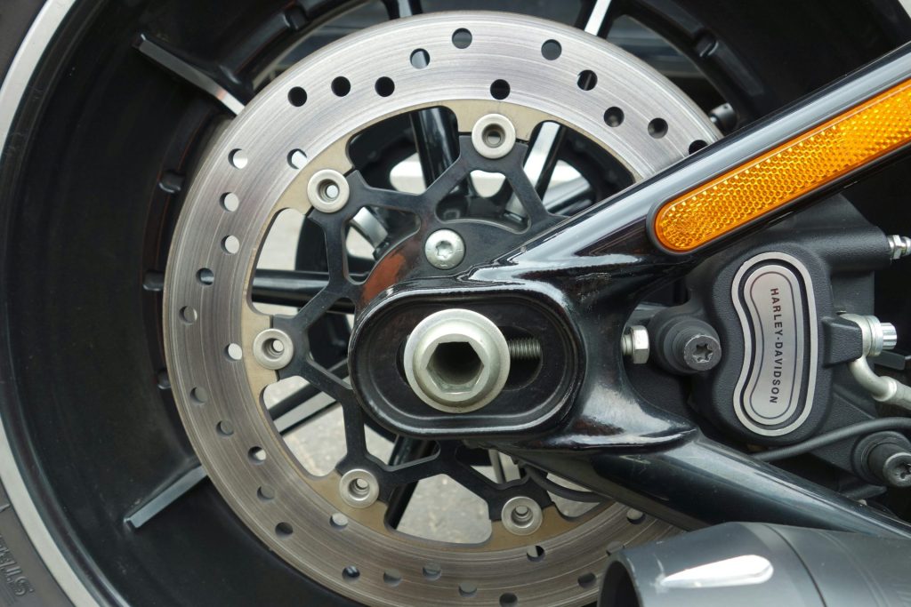 A close up of a motorcycle wheel and brake